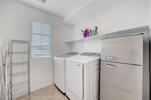 laundry room featuring laundry area, baseboards, and washer and clothes dryer