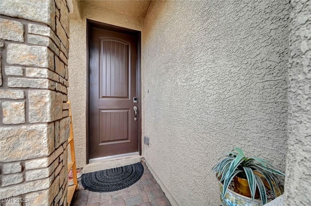 entrance to property with stucco siding