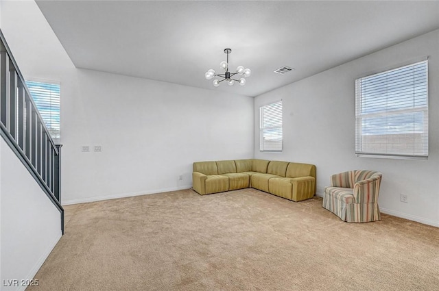 unfurnished living room featuring a chandelier, carpet floors, visible vents, baseboards, and stairs