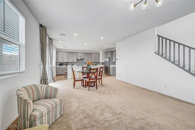 dining room featuring recessed lighting, light carpet, and visible vents