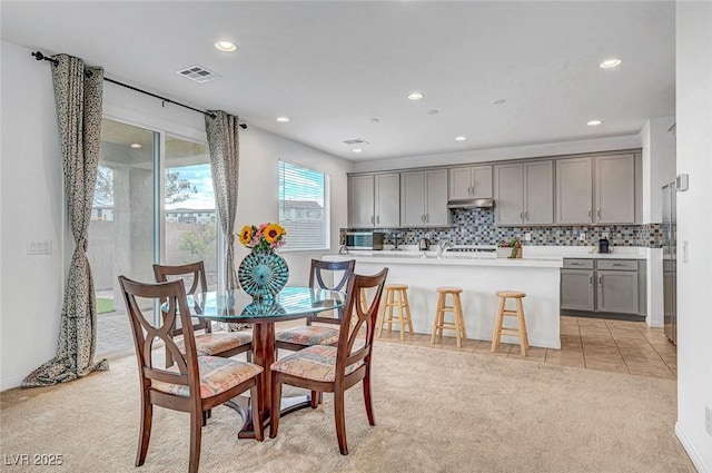 dining area featuring recessed lighting, light carpet, visible vents, and light tile patterned floors