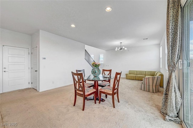 dining room with a chandelier, recessed lighting, light colored carpet, visible vents, and stairs