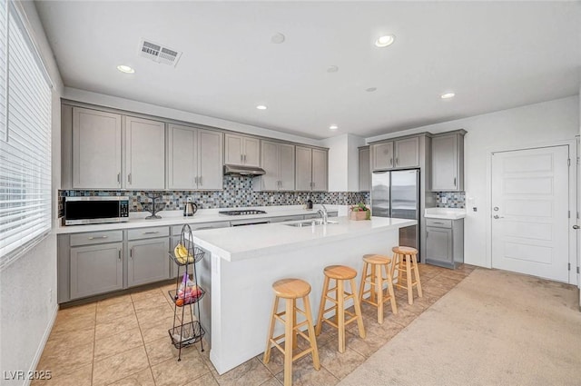 kitchen featuring appliances with stainless steel finishes, visible vents, and gray cabinetry