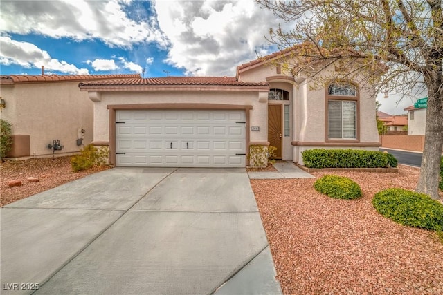 mediterranean / spanish-style house with a garage, a tile roof, driveway, and stucco siding