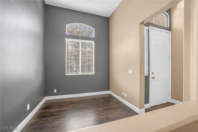 interior space with baseboards and wood finished floors