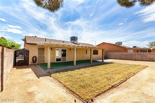 back of house featuring a gate, central air condition unit, stucco siding, and fence