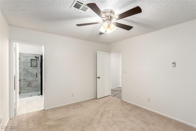 unfurnished bedroom with ensuite bath, light carpet, baseboards, and visible vents