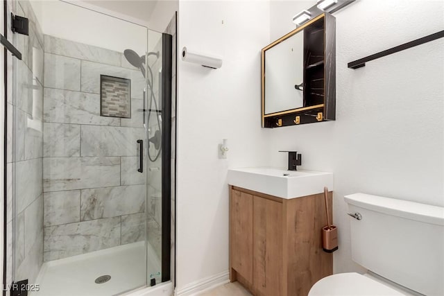full bathroom featuring toilet, vanity, and a stall shower