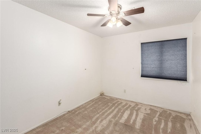 carpeted empty room with a textured ceiling and ceiling fan