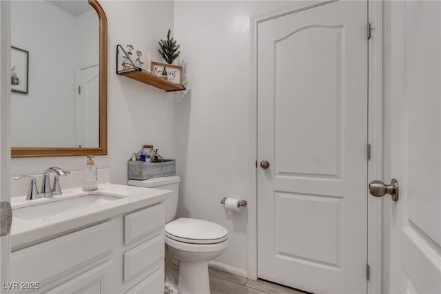 half bath featuring toilet and vanity