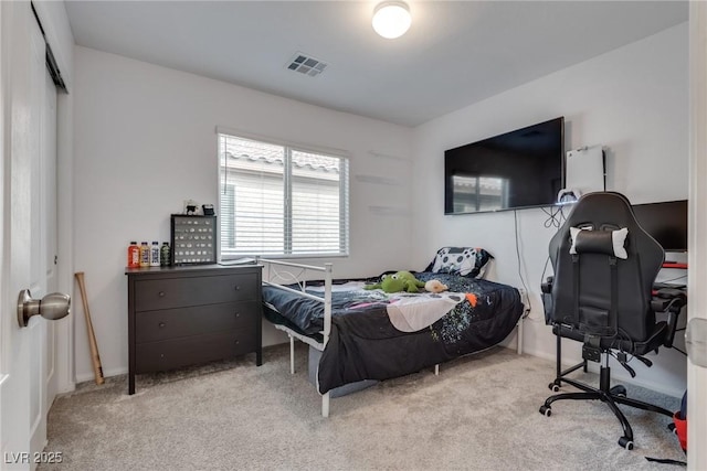 bedroom featuring visible vents and light colored carpet