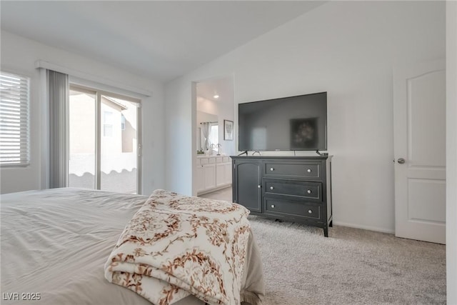 bedroom with access to exterior, light carpet, vaulted ceiling, and ensuite bath