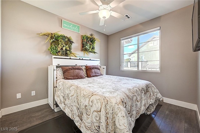 bedroom featuring a ceiling fan, dark wood-style flooring, visible vents, and baseboards