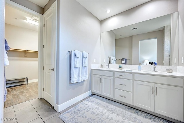 full bath with tile patterned floors, visible vents, a sink, and double vanity