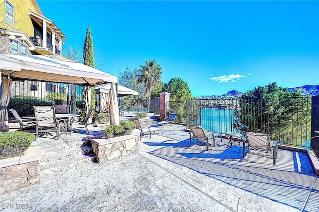 view of patio featuring a gazebo and fence