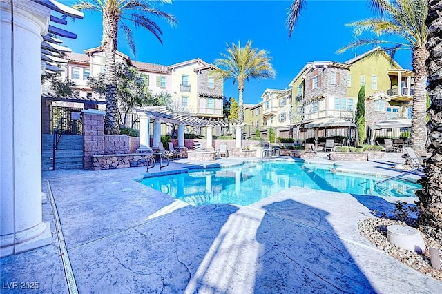 pool featuring a patio, a residential view, and a pergola