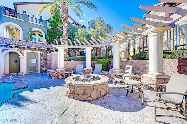 view of patio / terrace with an outdoor fire pit and a pergola