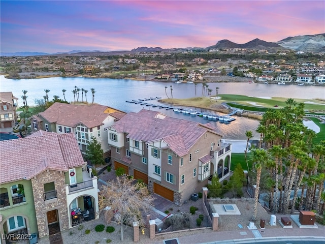 aerial view at dusk with a residential view and a water and mountain view