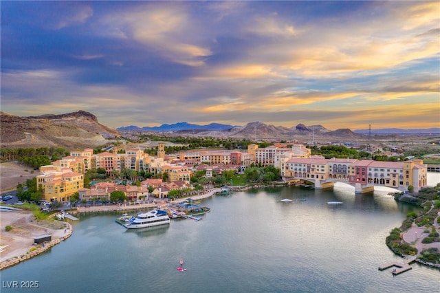 drone / aerial view with a water and mountain view