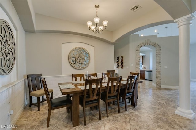 dining area featuring visible vents, arched walkways, light tile patterned flooring, decorative columns, and a chandelier