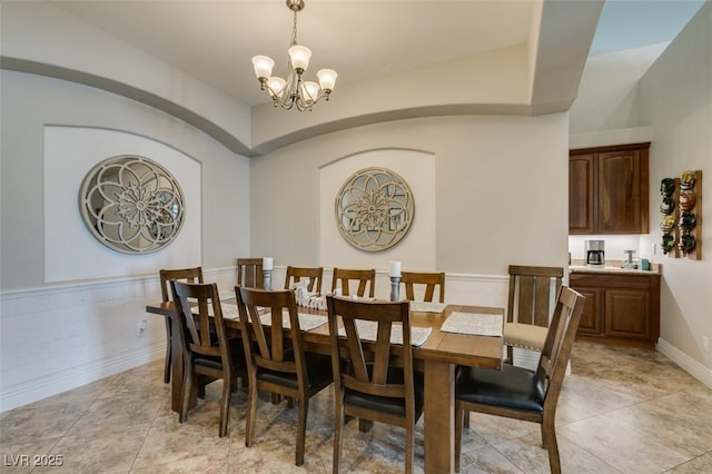 dining space featuring light tile patterned floors and a chandelier