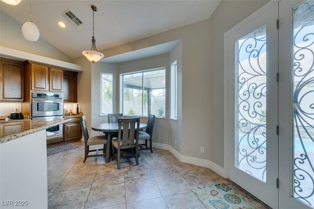 interior space with light stone counters, visible vents, vaulted ceiling, french doors, and double oven