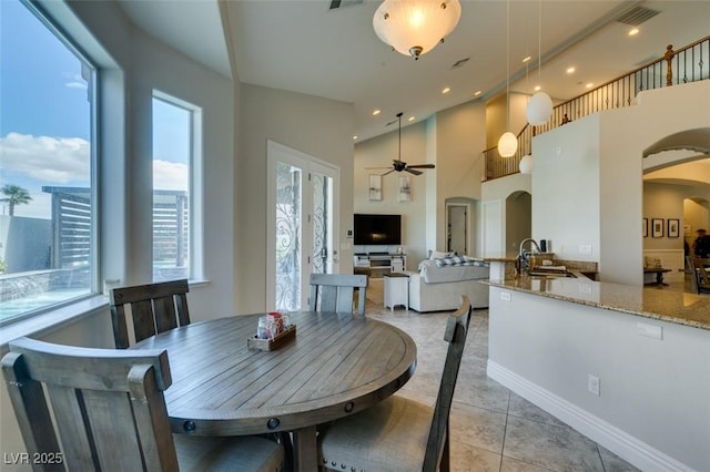 dining room with arched walkways, visible vents, recessed lighting, and a ceiling fan