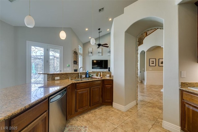 kitchen featuring light stone countertops, visible vents, arched walkways, a sink, and dishwasher