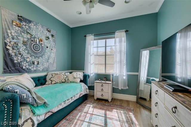 bedroom featuring ceiling fan, baseboards, wood finished floors, and ornamental molding