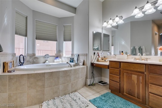 full bathroom with tile patterned floors, a bath, and vanity