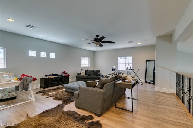 living area with visible vents, recessed lighting, and light wood-style floors