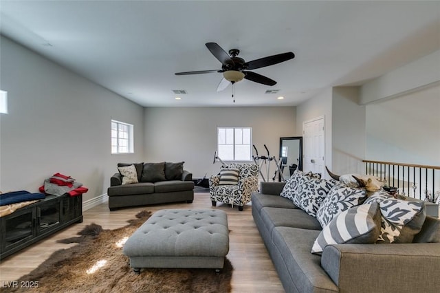 living area with visible vents, a healthy amount of sunlight, and wood finished floors