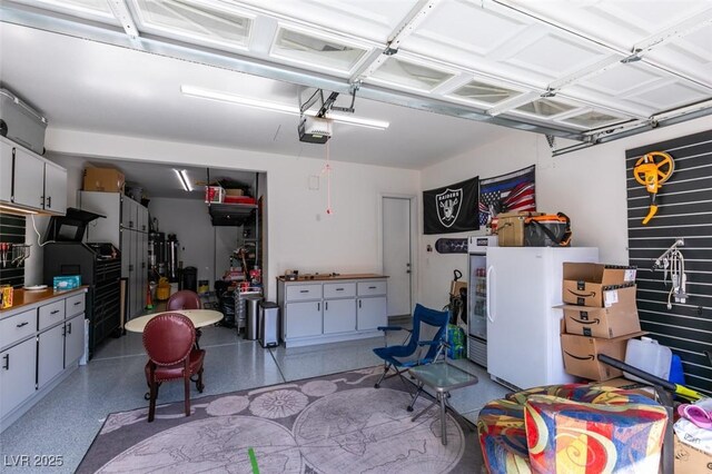 garage with freestanding refrigerator and a garage door opener