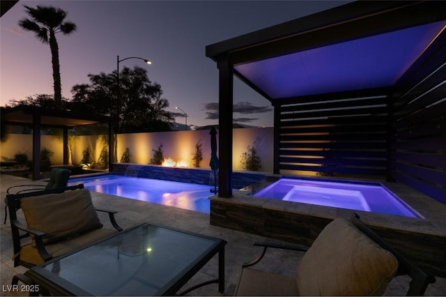 pool featuring a fenced backyard, an in ground hot tub, and a patio