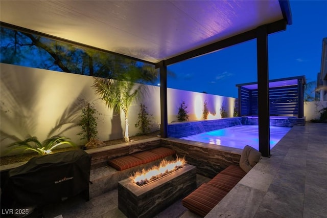 view of swimming pool with area for grilling, a fenced backyard, a fenced in pool, and an outdoor fire pit