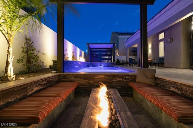 patio at twilight featuring an outdoor living space, an outdoor hot tub, and a fenced in pool