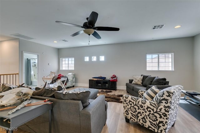 living room with recessed lighting, visible vents, baseboards, and light wood-style flooring