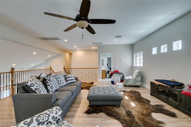 living area featuring recessed lighting, visible vents, and wood finished floors