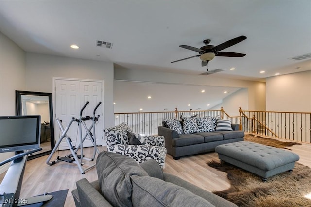 living room with recessed lighting, wood finished floors, and visible vents