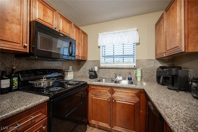 kitchen with black appliances, a textured ceiling, backsplash, and a sink