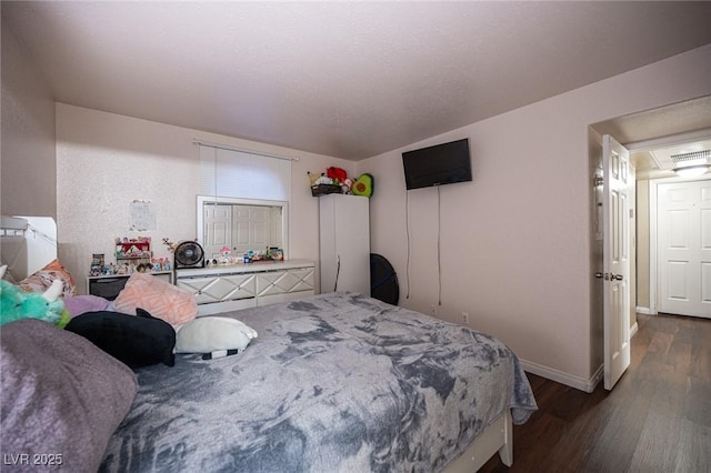 bedroom with dark wood-style floors and baseboards