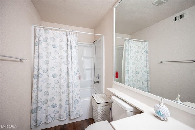 full bathroom featuring toilet, shower / tub combo, visible vents, and a textured ceiling