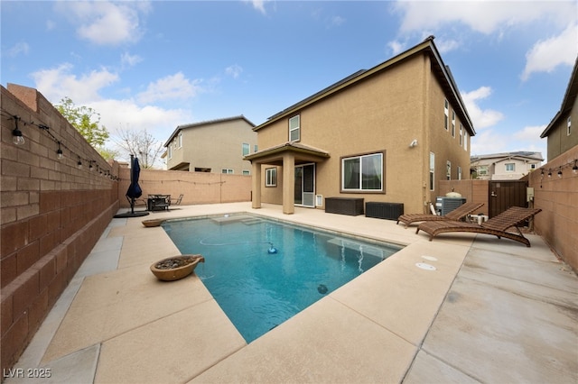 view of swimming pool featuring a patio, a fenced backyard, and a fenced in pool