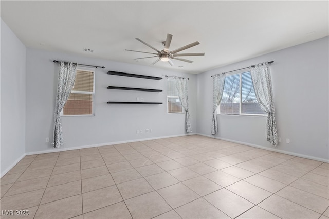 unfurnished room with visible vents, baseboards, and ceiling fan