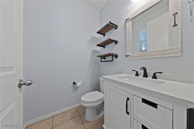 bathroom featuring tile patterned floors, toilet, vanity, and baseboards