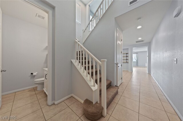 stairs featuring tile patterned flooring, recessed lighting, baseboards, and visible vents