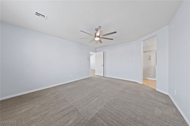 carpeted empty room featuring visible vents, baseboards, and a ceiling fan