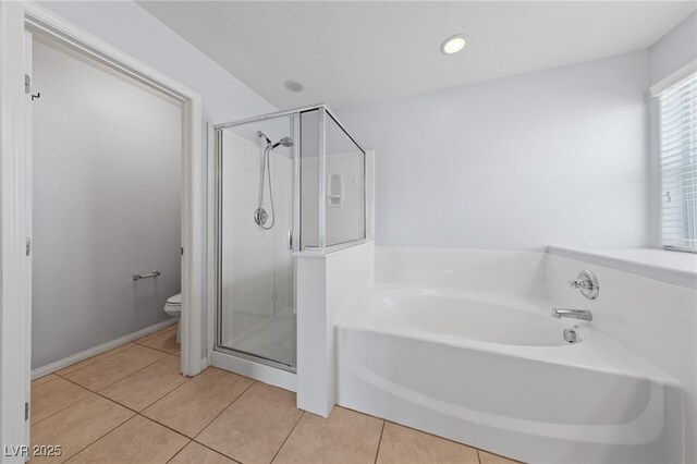 full bath featuring tile patterned floors, toilet, a bath, and a shower stall