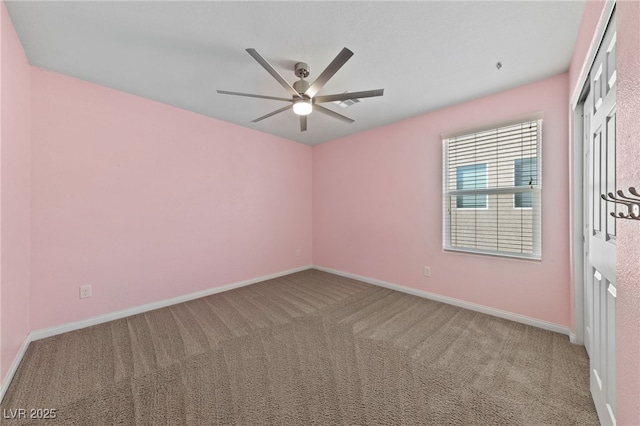 empty room featuring baseboards, carpet, and ceiling fan