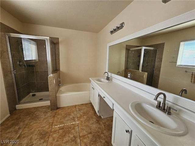 full bath featuring a stall shower, double vanity, a sink, and a bath